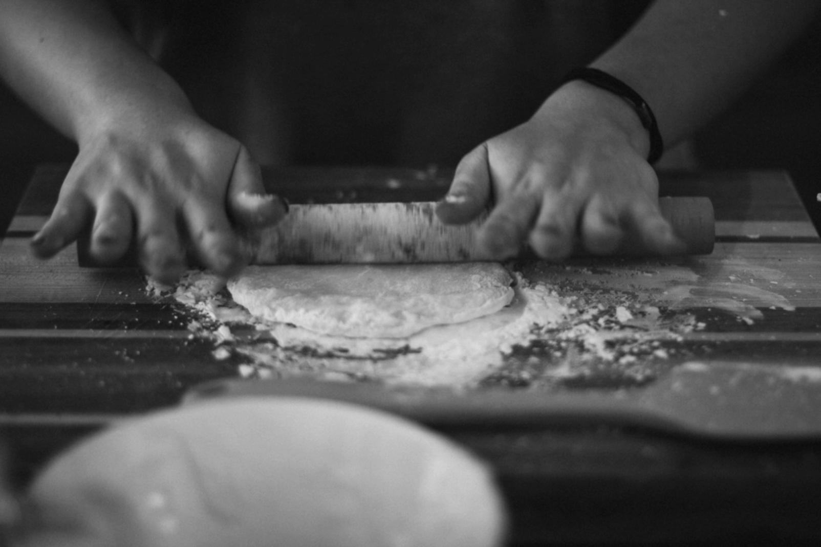 Wood fired pizza oven techniques being practiced by students